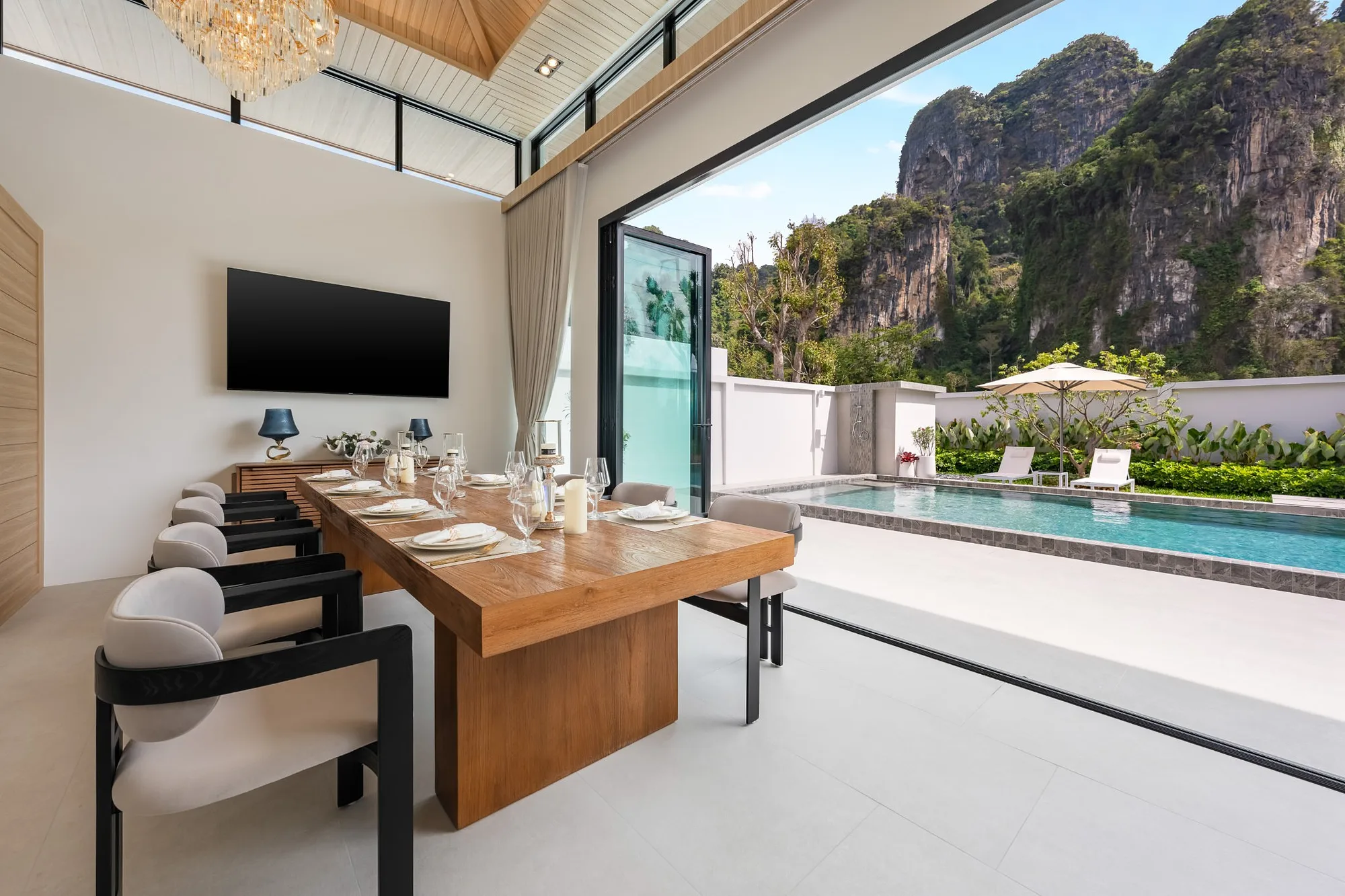 Dining area open to the pool and cliffs