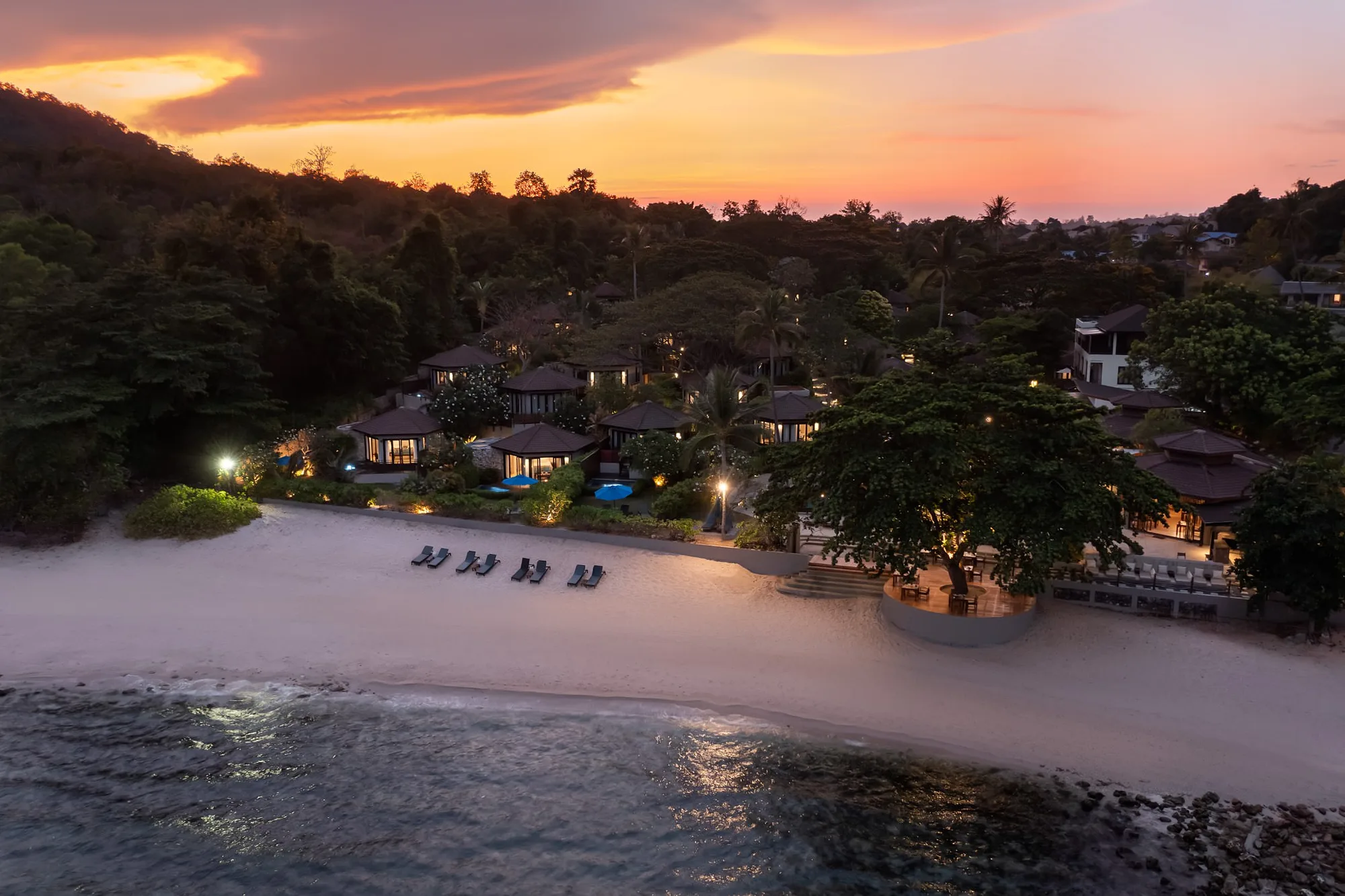 The resort and its beach from the air at dusk
