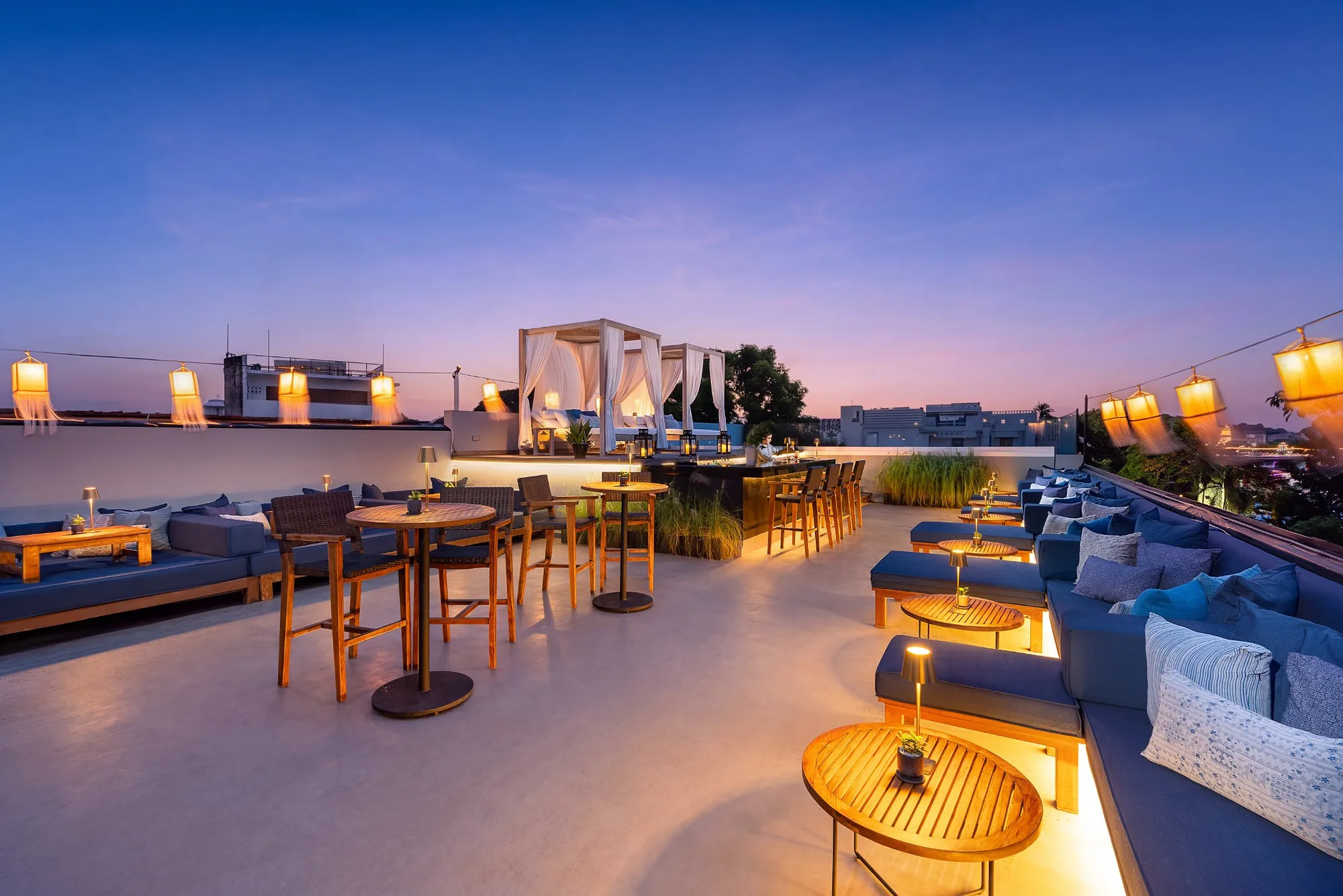 Rooftop bar at dusk above the Ping river