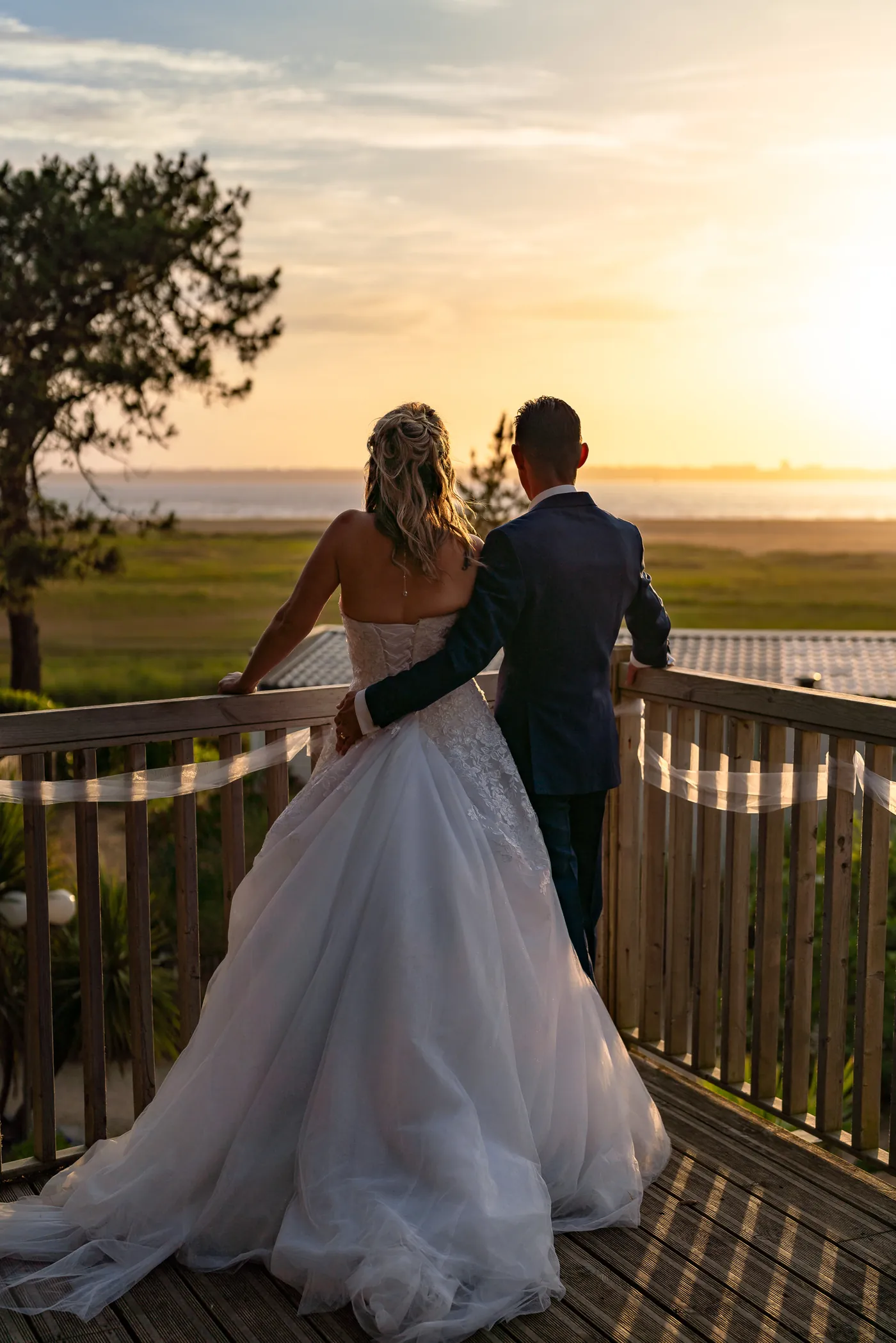 Bride and groom watching the sunset together