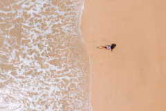 Woman relaxing in empty beach