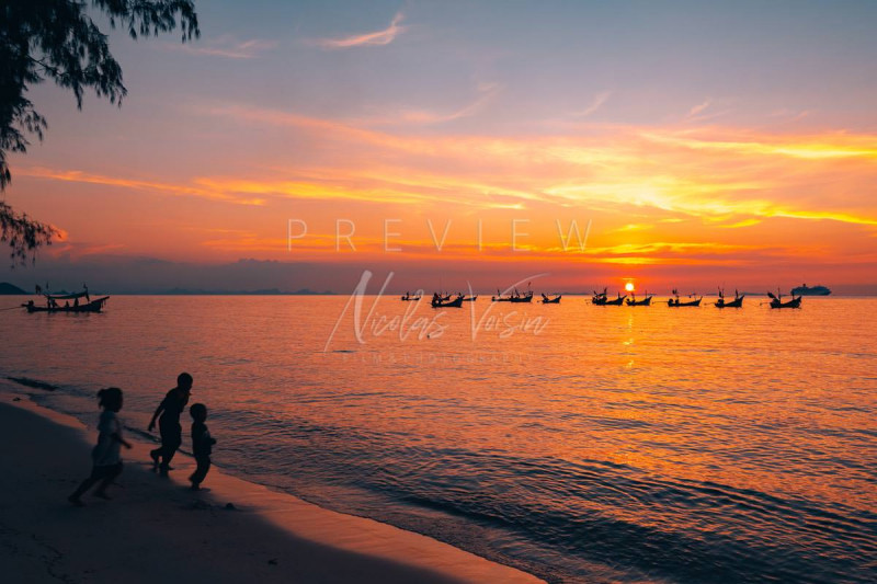 Kids playing at Nathon beach at sunset